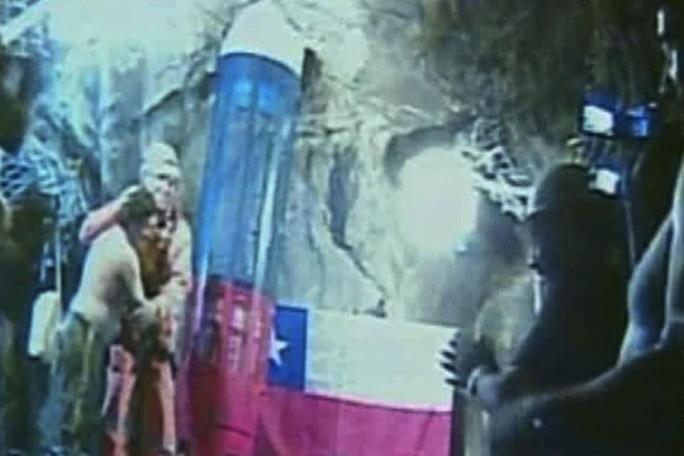 In this screen grab taken from video, rescuer Manuel Gonzalez Pavez, second left, is greeted by the trapped miners at San Jose Mine near Copiapo, Chile.(AP Photo)