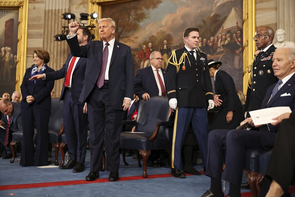 President Donald Trump gestures during the 60th Presidential Inauguration in the Rotunda of the US Capitol in Washington (Chip Somodevilla/Pool Photo via AP)