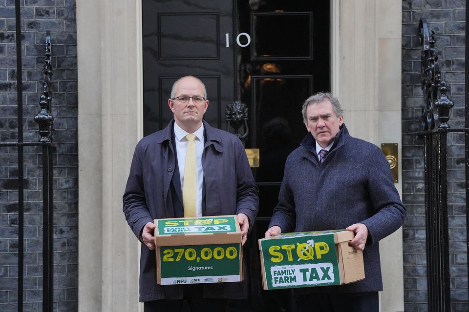 NFU president Tom Bradshaw, left, and NFU Cymru president Aled Jones handing in a petition at 10 Downing Street (Jonathan Brady/PA)