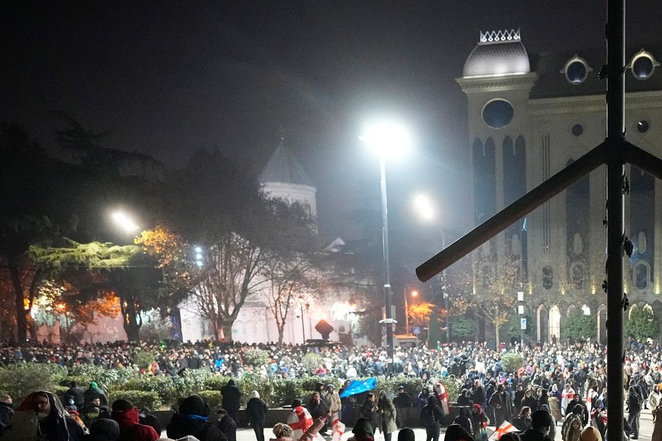 Demonstrators light candles during a rally (Pavel Bednyakov/AP)