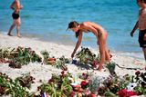 thumbnail: SOUSSE, TUNISIA - JUNE 30:  Holidaymakers lay flowers on Marhaba beach, where 38 people were killed in a terrorist attack last Friday, on June 30, 2015 in Sousse, Tunisia. British police have been deployed to the area as part of one of the biggest counter terror operations since the London bombings on July 7, 2005. (Photo by Jeff J Mitchell/Getty Images)