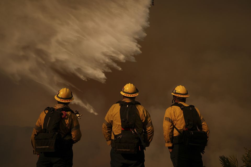 Firefighters have criticised the lack of water available after fire hydrants had run dry (Eric Thayer/AP)