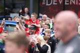 thumbnail: Clifonville fans wait to catch a glimpse of Irish Cup winners Cliftonville Football players as they arrive at the Devinish bar on an open top bus to meets supporters.  Picture by Peter Morrison