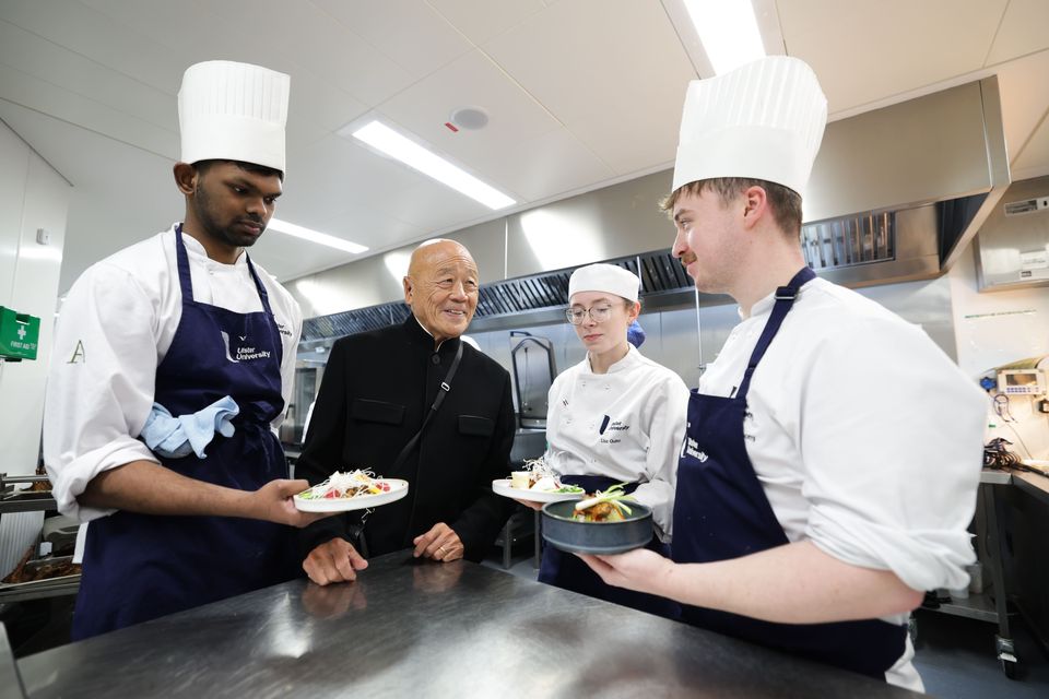 Ken Hom CBE pictured with Ulster University Culinary Arts Management and International Hospitality Management students Leslin Joy (left), Lisa Quinn (centre) and John O’Mahany (right).