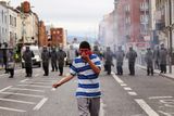 thumbnail: DUBLIN, IRELAND - MAY 17:  Police and protesters clash in the streets adjacent to the Garden on Remembrance where Queen Elizabeth II laid a wreath on May 17, 2011 in Dublin, Ireland. The Duke and Queen's visit is the first by a monarch since 1911. An unprecedented security operation is taking place with much of the centre of Dublin turning into a car free zone. Republican dissident groups have made it clear they are intent on disrupting proceedings.  (Photo by Oli Scarff/Getty Images)
