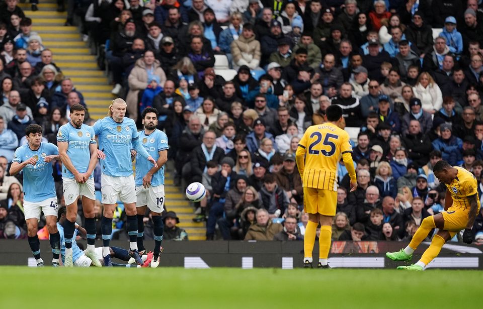 Pervis Estupinan, extreme right, scores Brighton’s first goal from a free-kick (Martin Rickett/PA)