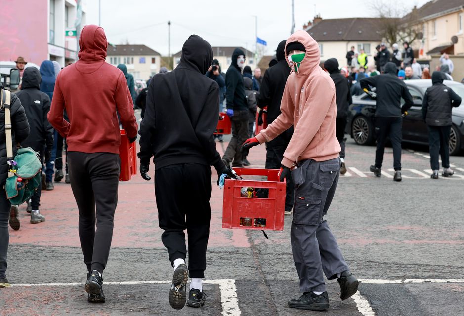 A group of young men carrying crates of petrol bombs at the start of an Easter Monday parade in the Creggan area of Londonderry, commemorating the anniversary of the Easter Rising Rebellion of 1916 (Liam McBurney/PA)