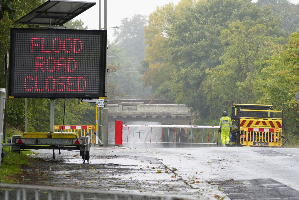 A sign warns of flooding ahead on a road in Liverpool (Peter Byrne/PA)