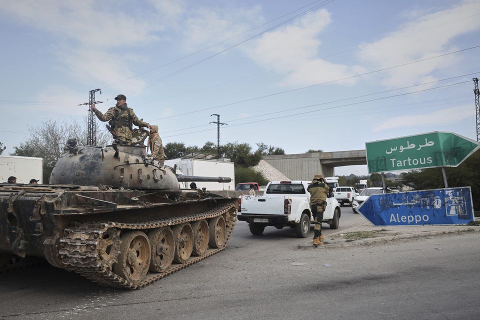 Reinforcement Syrian security forces deploy in the outskirts of Latakia, Syria, on Friday (Omar Albam/AP)