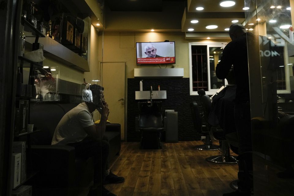 A photo of Hamas leader Yahya Sinwar is displayed on a TV screen at a barbershop in the West Bank city of Bethlehem (Mahmoud Illean/AP)