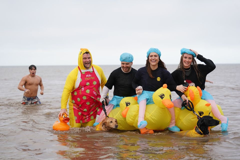 People take part in a Christmas Day dip at Hunstanton in Norfolk (Joe Giddens/PA)