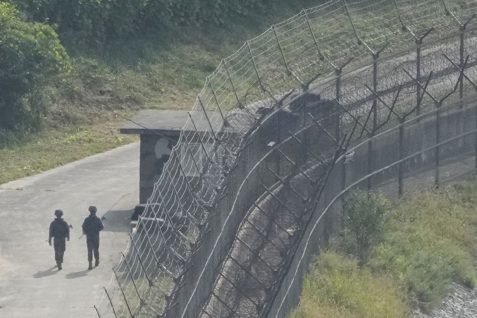 South Korean army soldiers patrol along the barbed-wire fence in Paju, South Korea, near the border with North Korea (Ahn Young-joon/AP)