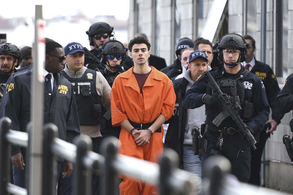 Luigi Mangione, a suspect in the fatal shooting of UnitedHealthcare CEO Brian Thompson, is escorted by police. (AP/Pamela Smith)