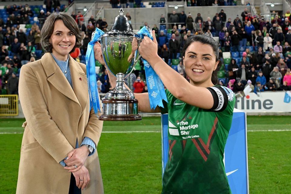 Jessica Foy receives the Electric Ireland Women's Cup from Anne Smyth after Glentoran's 2022 victory
