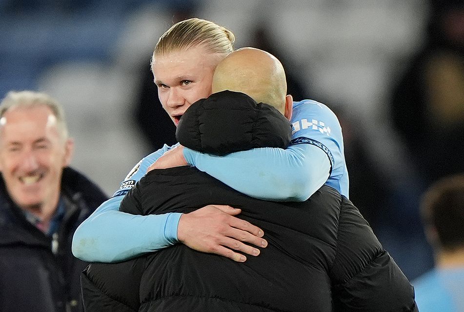 Manchester City’s Erling Haaland hugs manager Pep Guardiola after the game (PA)