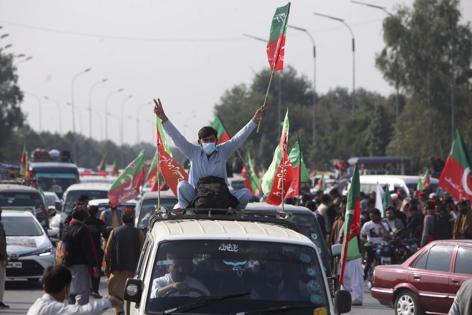 Supporters board into vehicles as they start a rally for Islamabad to demand Khan’s release (Muhammad Sajjad/AP)