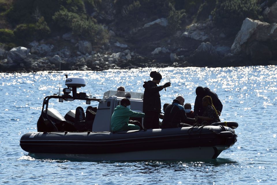 Survivors sit on a vessel after a boat carrying migrants ran into trouble off the coast of the eastern Aegean Sea island of Samos (Michael Svarnias/AP)