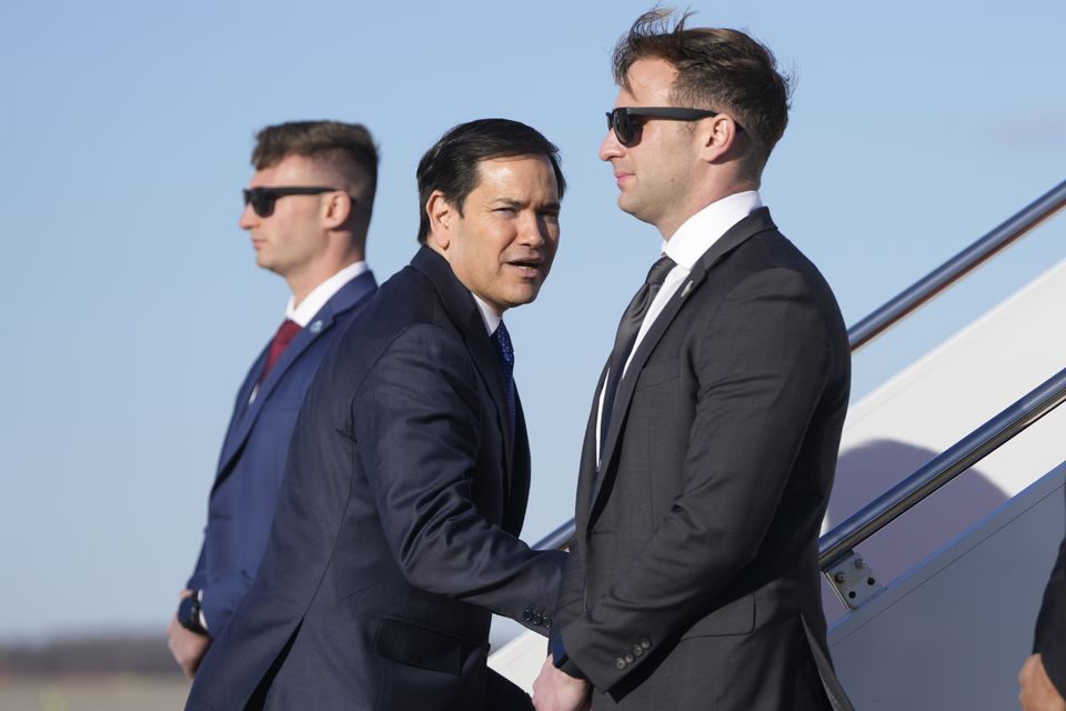 Secretary of State Marco Rubio, centre, boards a plane at Joint Base Andrews, Md., en route to Panama. (AP/Mark Schiefelbein)