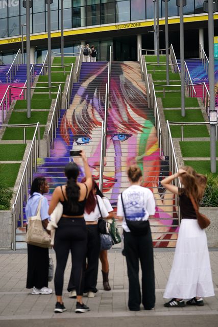 Swifties take photographs of the Swiftie Steps and murals at Wembley Park, ahead of Taylor Swift’s Era’s Tour concert on Thursday (Yui Mok/PA)