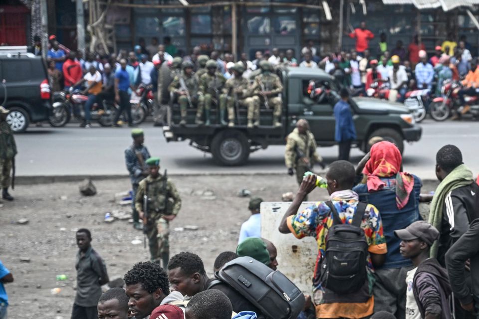 M23 rebels escort government soldiers and police who surrendered to an undisclosed location in Goma (Moses Sawasawa/AP)