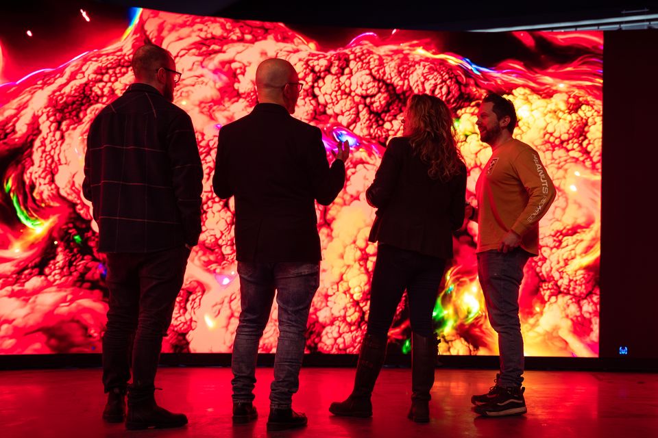 A group before a state-of-the-art screen inside the new studio (Abertay University/PA)