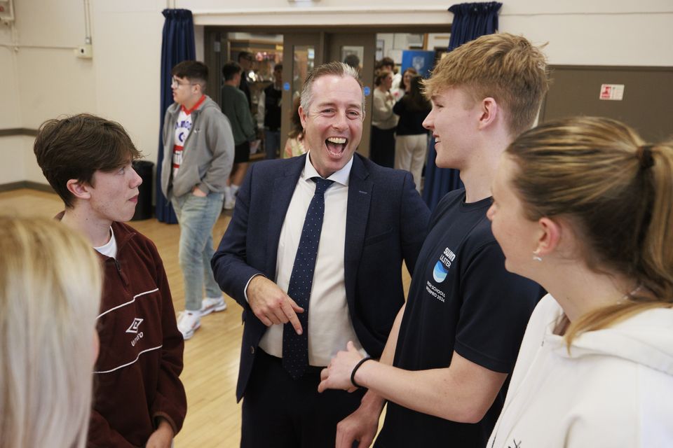 Northern Ireland’s Education Secretary Paul Given (centre) joined in with the celebrations among these students at Belfast High School (Liam McBurney/PA)