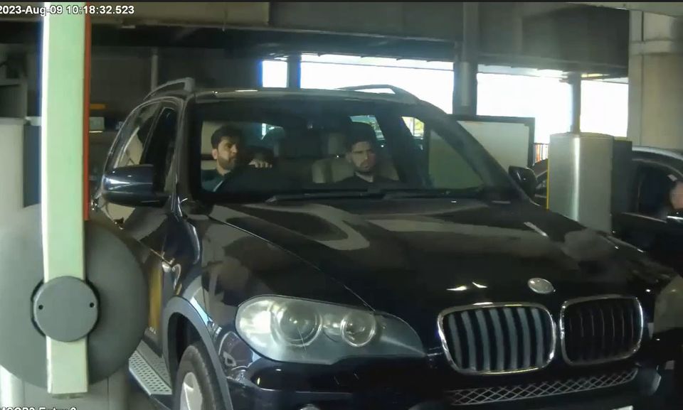 Image of Sara Sharif’s father, Urfan Sharif, and uncle, Faisal Malik, in the front seat of a car arriving at Heathrow Airport in London (Surrey Police/PA)