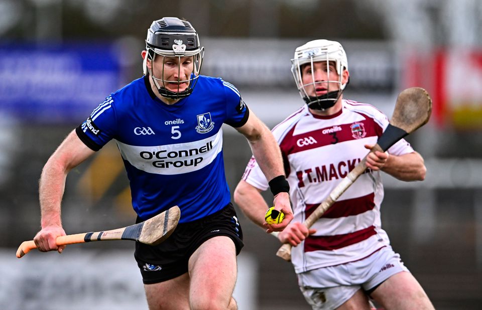 Sarsfields' Bryan Murphy races away from Conor McAllister of Slaughtneil during the sides' clash