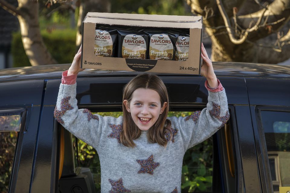 Grace, from Edinburgh, with her year’s supply of haggis crisps (Mike Wilkinson/Taylors Snacks/PA)