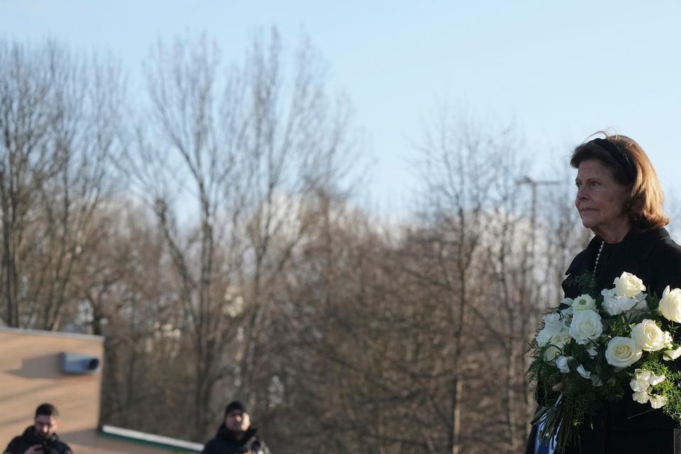 Sweden’s King Carl XVI Gustaf and Queen Silvia arrive to place flowers at the memorial (Sergei Grits/AP)