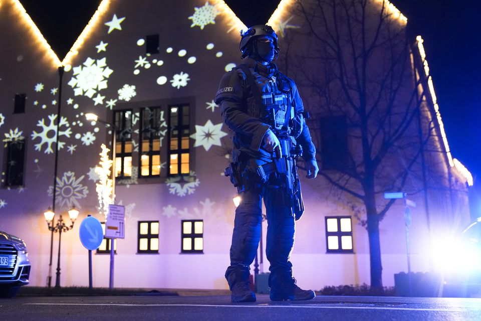 A police officer guards a cordoned-off area of the market in Magdeburg (Ebrahim Noroozi/AP)