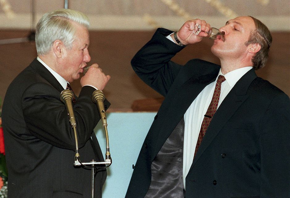 Former Russian president Boris Yeltsin, left, and Alexander Lukashenko drink a toast celebrating the signing of an agreement in the Kremlin in Moscow, Russia, on April 2, 1996 (Pool Photo via AP)