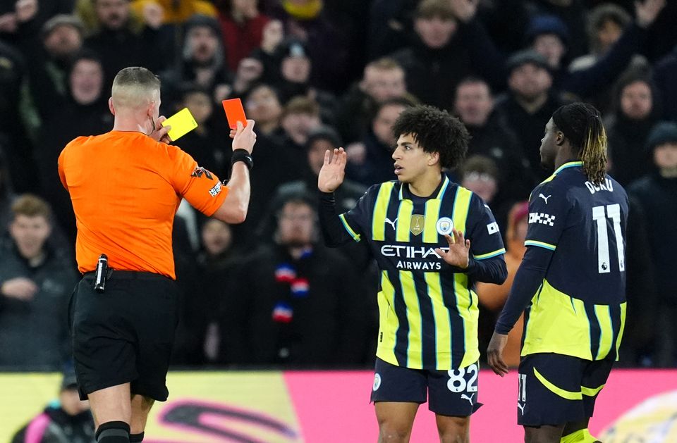 Referee Chris Graham shows a red card to Lewis (Adam Davy/PA)