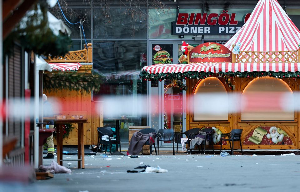 Blankets and chairs of injured people stand behind a barrier at Magdeburg's Christmas market. (Jan Woitas/dpa via AP)