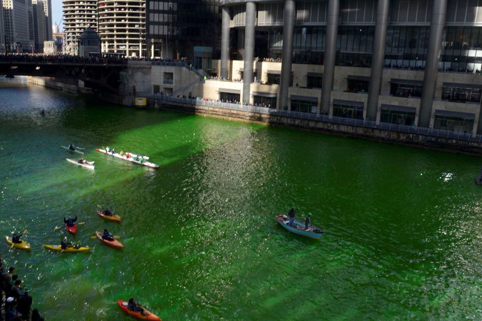 Kayakers float on the Chicago River after being dyed green ahead of the St. Patrick's Day parade in Chicago, Saturday, March 14, 2015. (AP Photo/Paul Beaty)