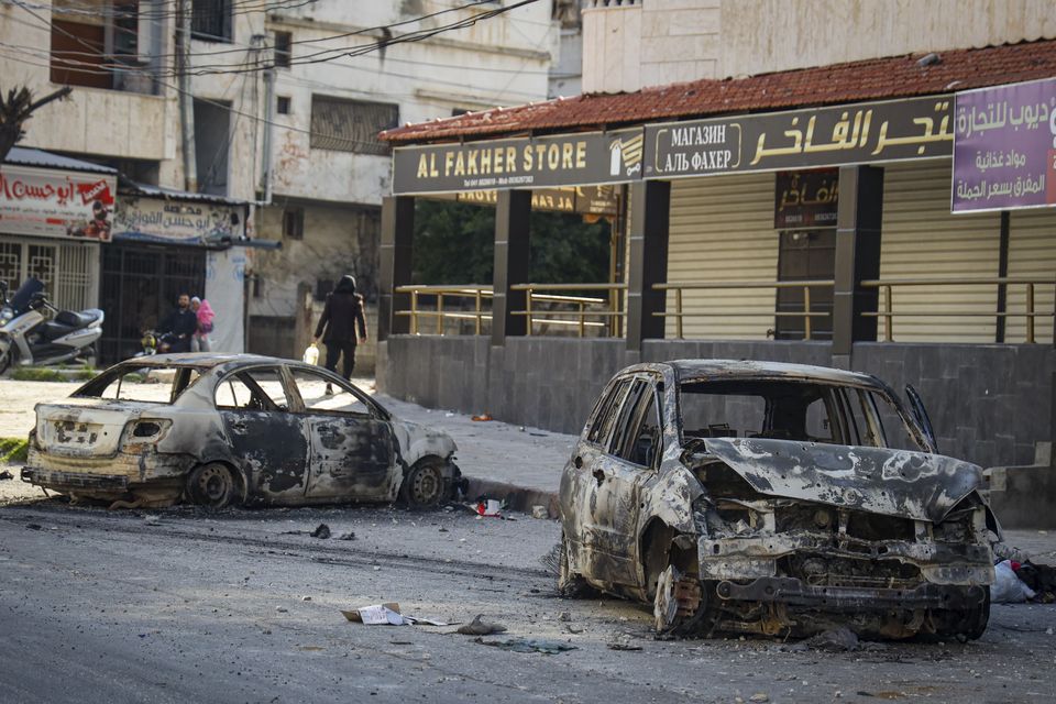 Burnt-out cars in the town of Jableh following the recent wave of violence between Syrian security forces and gunmen loyal to former president Bashar Assad (Omar Albam/AP)