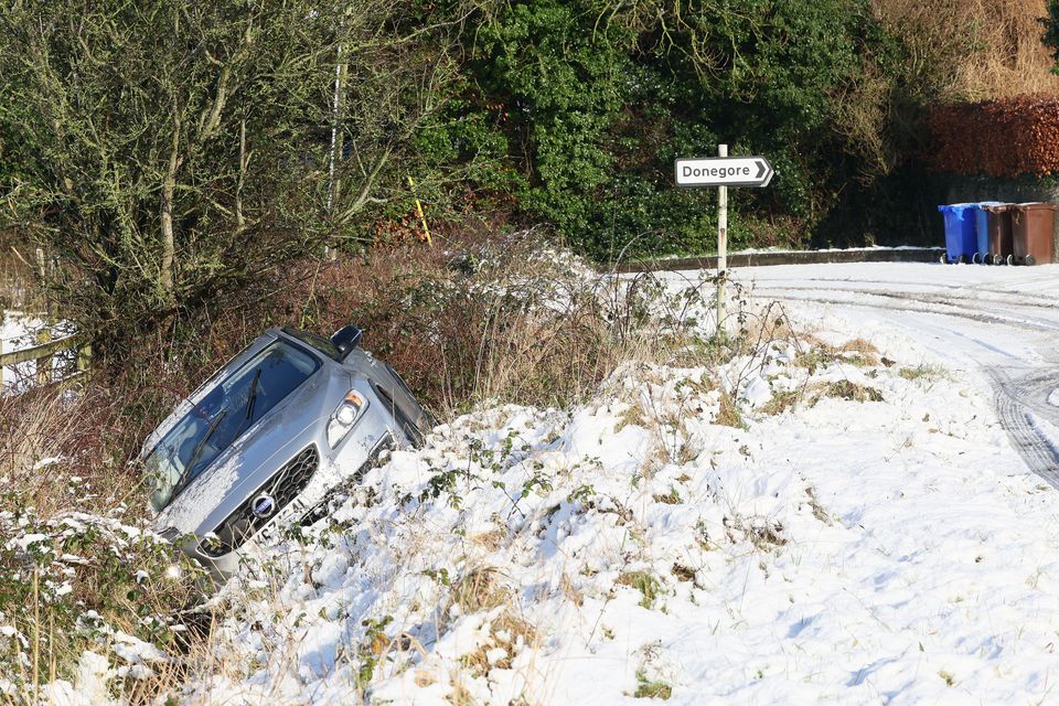 A car lies in a ditch after sliding off the road near Donegore in Co. Antrim today. Photo: Stephen Davison/Pacemaker