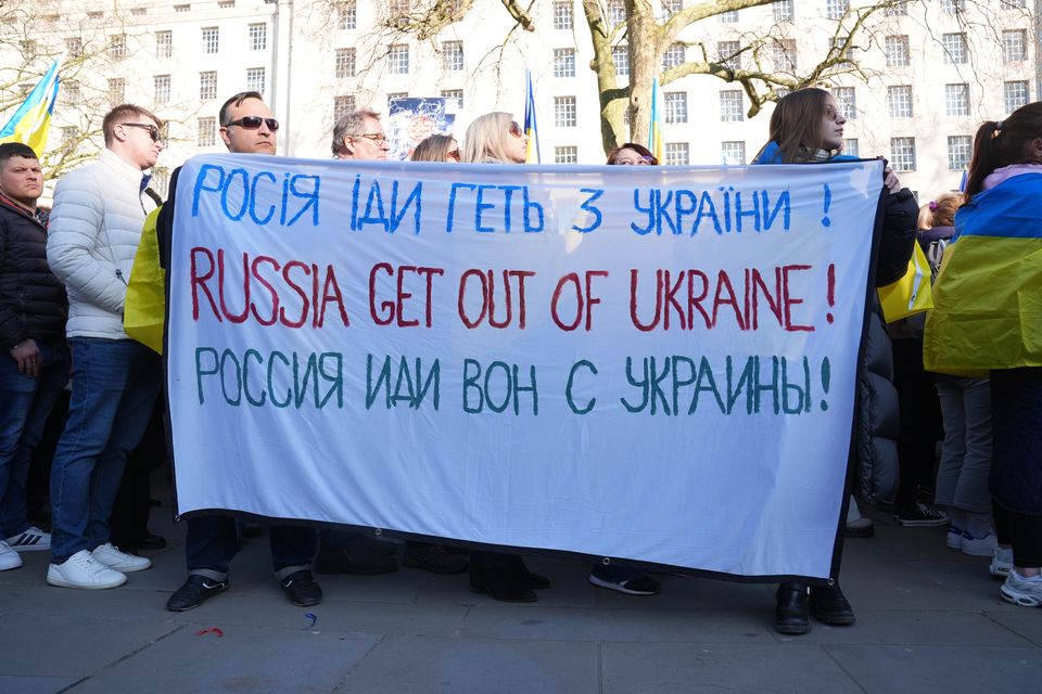 Pro-Ukraine protesters hold banners outside Downing Street (Lucy North/PA)