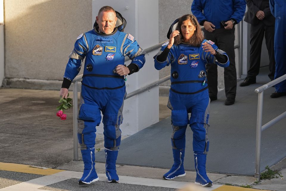 Nasa astronauts Butch Wilmore, left, and Suni Williams leave the operations and checkout building (John Raoux/AP)