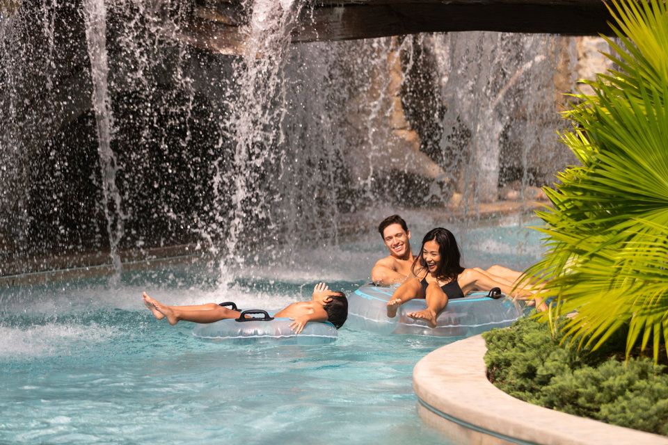 A family relaxing in the lazy river at the hotel