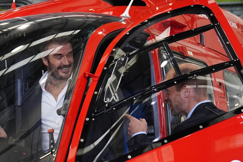 The Prince of Wales with David Beckham sitting in the cockpit of one of the new London Air Ambulance Charity helicopters (Aaron Chown/PA)