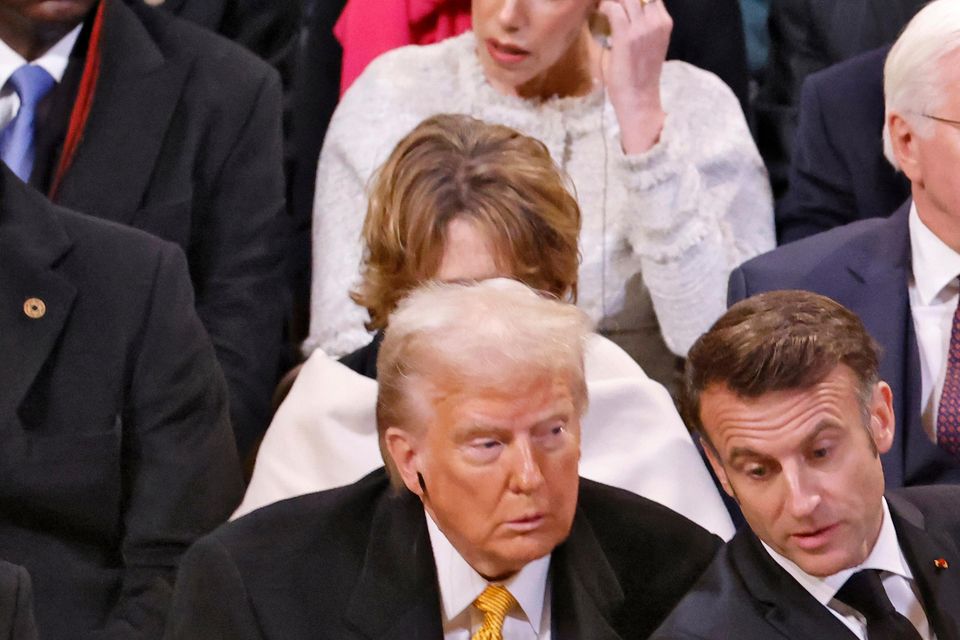 Emmanuel Macron points towards Germany’s President Frank-Walter Steinmeier, right rear, as he talks with Donald Trump in Notre Dame Cathedral (Ludovic Marin, Pool via AP)