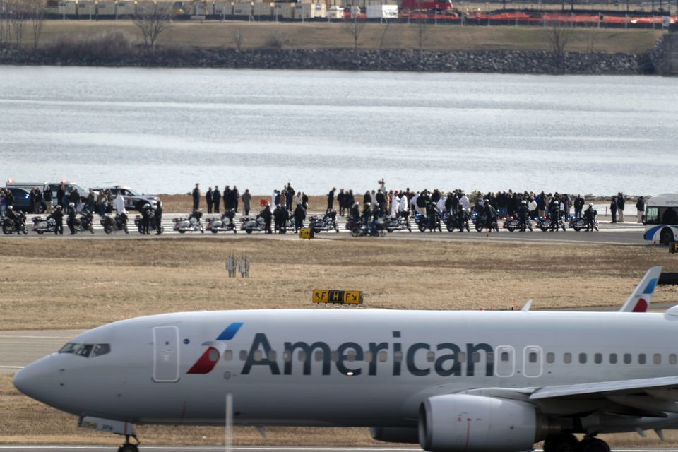 Families of the victims stand near the wreckage site in the Potomac River (Jose Luis Magana/AP)