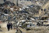thumbnail: People walk amid the rubble in Rikuzentakata, Iwate prefecture, northern Japan, Sunday, March 13, 2011, two days after the powerful earthquake-triggered tsunami hit the country's east coast. (AP Photo/Kyodo News) JAPAN OUT, MANDATORY CREDIT, NO SALES IN CHINA, HONG  KONG, JAPAN, SOUTH KOREA AND FRANCE