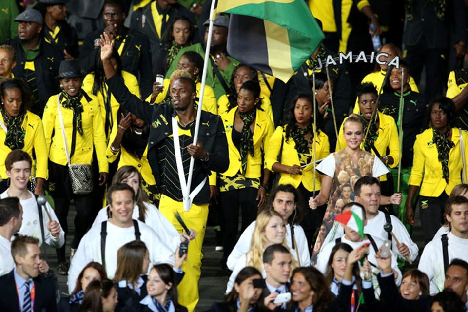 Jamaica's Usain Bolt carries his countries flag at the Opening Ceremony at the Olympic Stadium, London. PRESS ASSOCIATION Photo. Picture date: Friday July 27, 2012. See PA story OLYMPICS Ceremony. Photo credit should read: Mike Egerton/PA Wire. EDITORIAL USE ONLY
