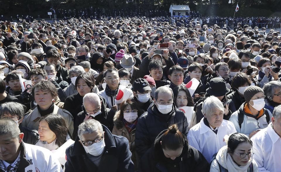 Crowds gather to see members of the royal on the balcony of the Imperial Palace (Kyodo News/AP)