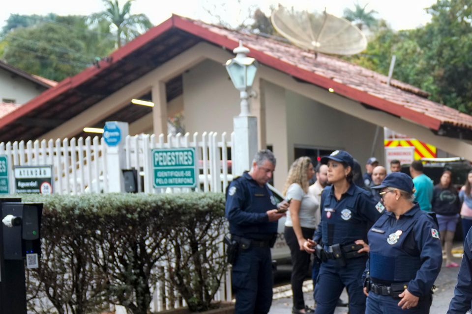 Police guard the gated community where a plane crashed in Vinhedo, Sao Paulo state, Brazil (Andre Penner/AP)