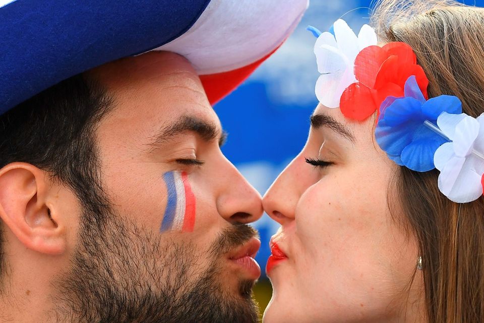 The beautiful game - football fans from around the world -   -A man and a woman supporting France kiss prior to the Euro 2016 group A football match between France and Romania at Stade de France, in Saint-Denis, north of Paris