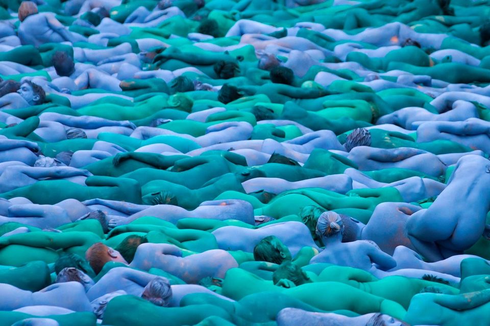 Naked volunteers, painted in blue to reflect the colours found in Marine paintings in Hull's Ferens Art Gallery, prepare to participate in US artist, Spencer Tunick's "Sea of Hull" installation on the Scale Lane swing bridge in Kingston upon Hull on July 9, 2016. AFP/Getty Images