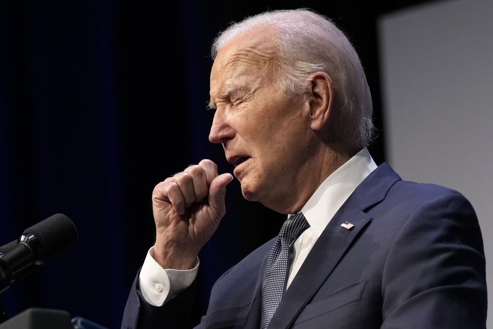 President Joe Biden coughs during an event in Las Vegas shortly before being diagnosed with Covid-19 (Susan Walsh/AP)